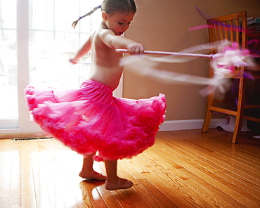 Caucasian girl twirling in skirt