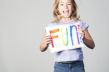 Happy Mixed Race girl holding fun sign