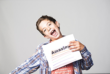 Proud Mixed Race boy holding awesome sign