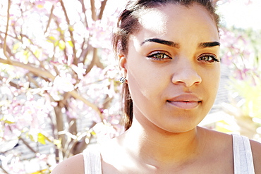 Portrait of serious Mixed Race woman outdoors