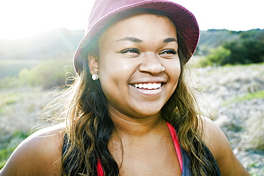 Mixed Race teenager smiling in field