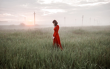 Caucasian woman walking in remote field