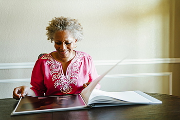 Black woman enjoying photo album