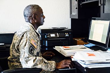 Black soldier using computer