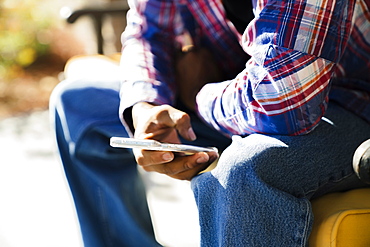 Black man texting on cell phone