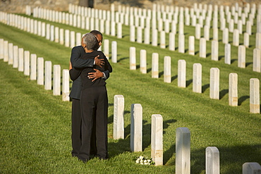 Black couple hugging in military cemetery