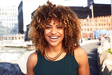 Black woman smiling at waterfront