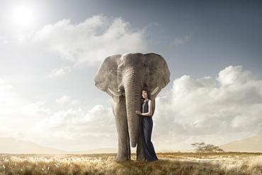 Woman hugging elephant in remote field