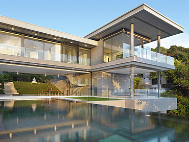 Pool out front of large modern home