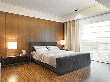 Gray striped bedding on bed in modern bedroom