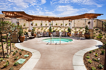 Chairs by small swimming pool