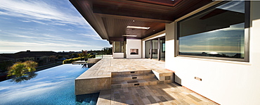 Swimming pool with luxury house against the sky at Newport Beach