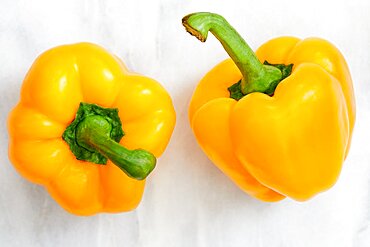 Studio shot of two yellow bell peppers