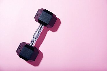 Dumbbell on pink background