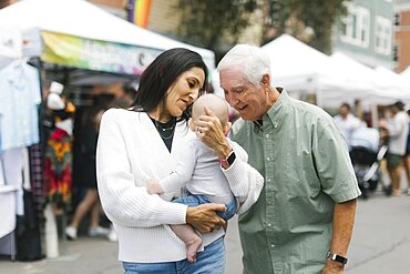 Grandparents holding baby grandson (6-11 months)