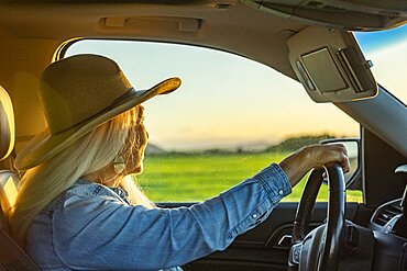 Blonde woman in car wearing cowboy hat