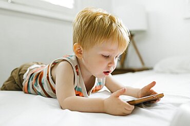 Boy (2-3) using smart phone