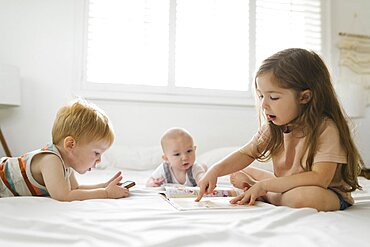 Siblings (6-11 months, 2-3) reading and using phone