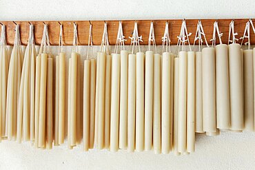 Hand-made candles hanging on wall