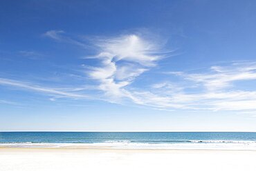 Empty beach on sunny day by Atlantic Ocean