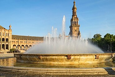 Spain, Seville, Fountain at Plaza de Espagna and church in background 