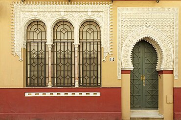 Spain, Seville, Moorish style building with arched entrance and windows 