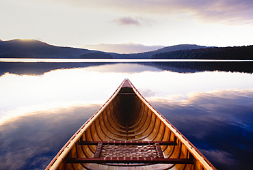 United States, New York, St. Armand, Lake Placid, Canoe in morning mist, Adirondacks State Park