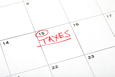 Tax day marked on wall calndar in red