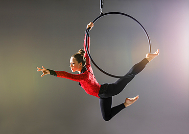 Teenage aerialist (14-15) practicing on gymnastics hoop