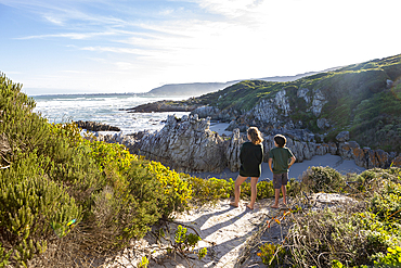 South Africa, Hermanus, Brother (10-11) and sister (16-17) looking at Atlantic Ocean in Voelklip Beach