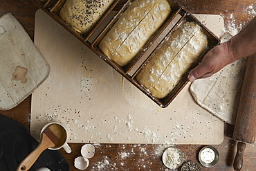 Directly above view of baker preparing bread in kitchen