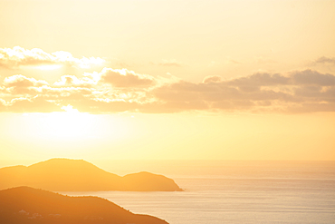 USA, United States Virgin Islands, St. John, Golden sunrise over calm Caribbean Sea