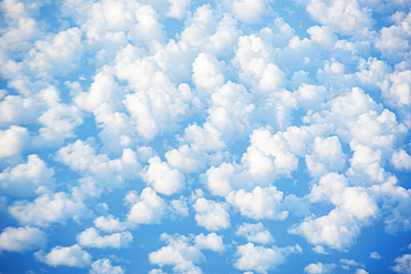 White cumulus clouds against blue sky