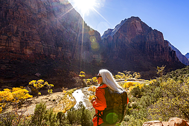 Woman hiking near Angels Landing Trail overlooking Virgin River