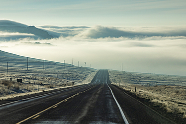 Clouds and fog over empty Idaho 20 road