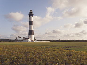 USA, North Carolina, Nags Head, Bodie Island Lighthouse in grassy field