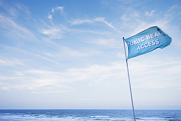 Blue Public Beach flag against sky at Topsail Beach