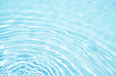 Ripples on turquoise pool water surface