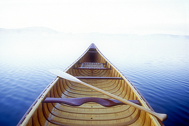 Wood canoe in morning mist on Saranac Lake
