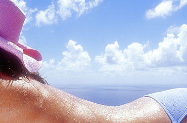 Close-up of woman sunbathing on beach