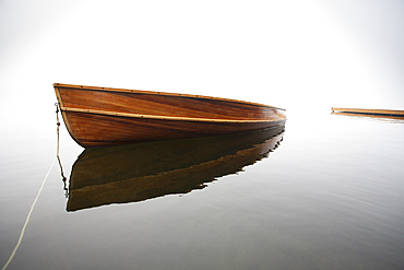 Wooden boat anchored on calm Lake Placid