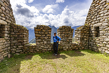 Portrait of smiling woman at Machu Picchu Inca ruins