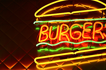 Neon hamburger sign at diner at night