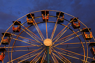 Low angle view of ferris wheel against sky at dusk