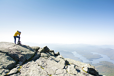 Rear view of man enjoying view of Lake Placid from Whiteface Mountain, Wilmington, New York State, USA