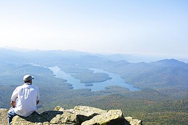 Rear view of man enjoying view of Lake Placid from Whiteface Mountain, Wilmington, New York State, USA