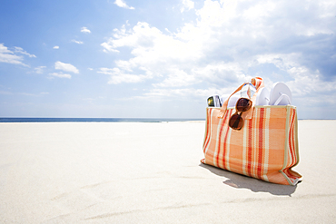 Beach bag on empty sandy beach, Spring Lake, New Jersey, USA