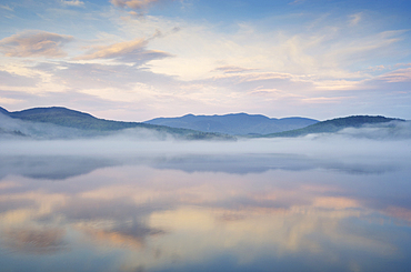 Evening mist rising on Lake Placid, Lake Placid, New York, USA