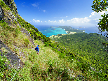 Woman hiking near Goathouse Cave on Lord Howe Island, Lord Howe Island, New South Wales, Australia