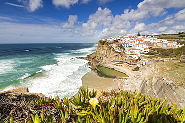 Top view of the perched village of Azenhas do Mar surrounded by the Atlantic Ocean and green vegetation, Sintra, Portugal, Europe